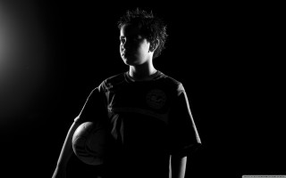 Young man soccer ball dark - his hands in free wallpaper for desktop