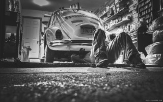 Man laying ground car garage - a car in a garage free wallpaper