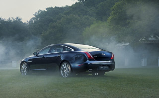 Black car smoke field trees - a house in the distance free wallpaper