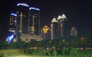 City skyline green field night - basuki abdullah free wallpaper
