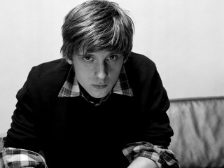 Young man couch serious look - david brewster free wallpaper