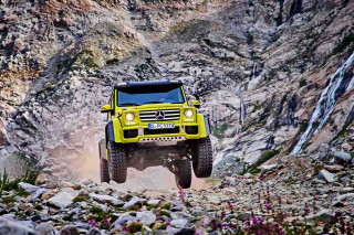 Yellow truck driving rocky area - a rocky area free wallpaper
