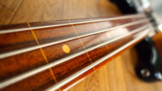 Guitar neck wooden table blurry - a wooden table top free wallpaper