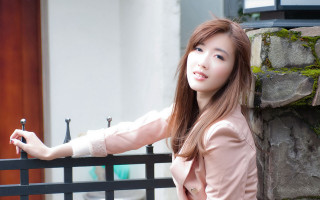 Woman fence hand rail building - a door in the background free wallpaper