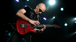 Man playing red guitar stage - a red guitar free wallpaper