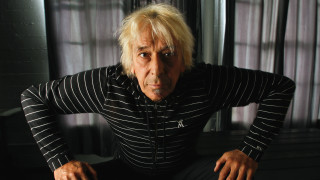 Surprised man sitting chair hands - bernie d’andrea free wallpaper