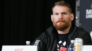 Bearded man sitting table microphone - a black curtain behind free wallpaper