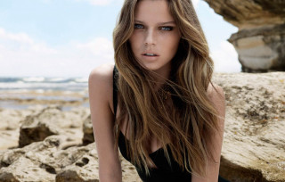 Woman black dress sitting rock - bettina heinenayech free wallpaper