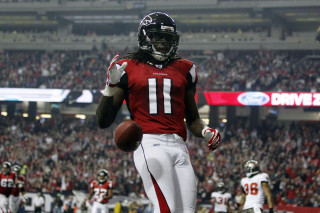 Football player running with ball 9 - his hand and a crowd free wallpaper