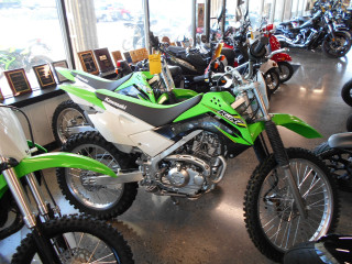 Green white dirtbike inside building - david budd free wallpaper