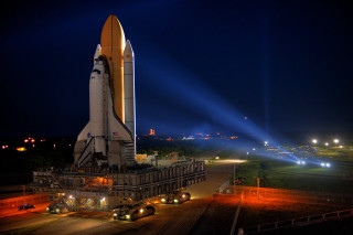 Large rocket night display lights - side and a building in the background free wallpaper