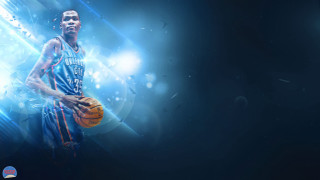 Basketball player holding basketball in 2 - his hand and a basketball free wallpaper