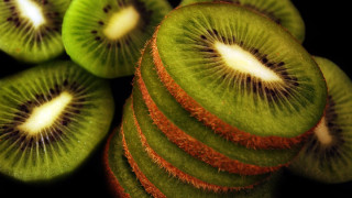 Kiwi slices stacked black surface - white dot free wallpaper for desktop
