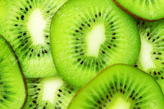 Kiwi fruit slice closeup white - black dot free wallpaper