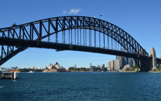Bridge boat cityscape water reflection - a city in the background and a boat free wallpaper