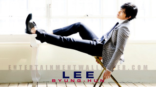 Man in suit tying feet - his foot free wallpaper