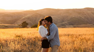Man woman kissing field grass 3 - romantic free wallpaper