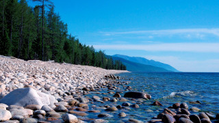 Rocky shoreline trees water blue - a rocky shore line free wallpaper