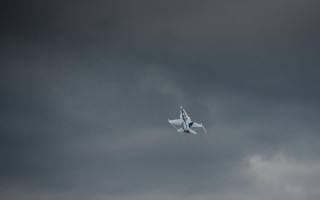 Plane flying dark sky clouds - a dark sky behind free wallpaper