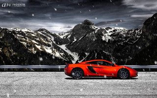 Red sports car mountain snow - a dark sky free wallpaper