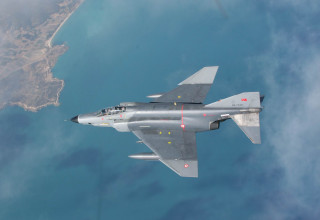 Fighter jet water city island - over a large body of water free wallpaper