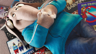 Stuffed elephant books magazines table - top of a pile free wallpaper