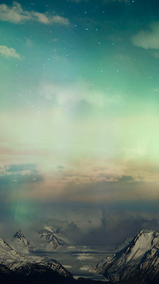 Mountain range green aurora light - a view of a mountain range free wallpaper for mobile
