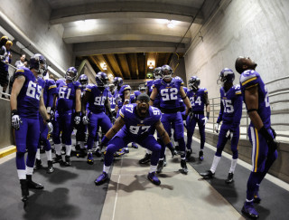 Football players tunnel uniforms helmets - a group of football players free wallpaper