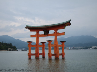 Large orange structure lake mountains - an abstract sculpture free wallpaper