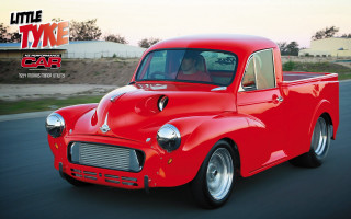 Red car driving street building 4 - a street next free wallpaper