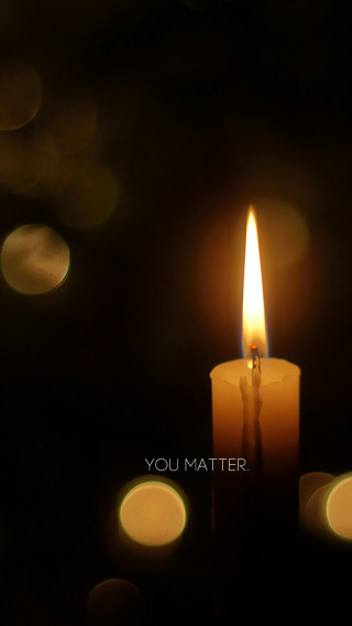 Candle lit candlestick blurry background - free light wallpaper for mobile