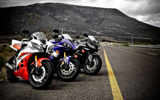 Motorcycles parked road mountain range 4 - a cloudy sky free wallpaper