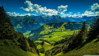 Scenic view valley mountains clouds - a scenic view of a valley free wallpaper for desktop