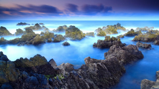 Rocky beach blue water cloudy - blue water free wallpaper