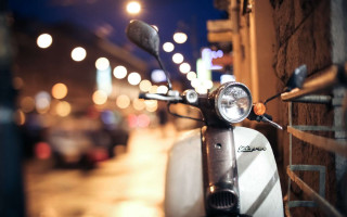 Scooter parked nighttime street lights - a scooter free wallpaper