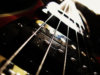 Guitar neck closeup blurry background - a close up of a guitar neck free wallpaper