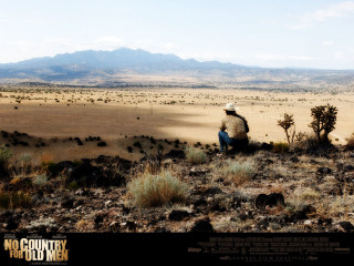 Man sitting hill desert landscape - over a desert landscape free wallpaper
