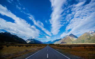 Long road cloudy sky mountains - a long road free wallpaper