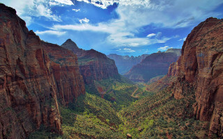 Scenic valley mountains trees sky 2 - a scenic view of a valley free wallpaper