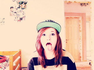 Girl funny face room bed - a door in the background free wallpaper