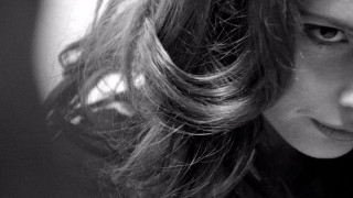 Woman long hair serious look 4 - her face and shoulder free wallpaper