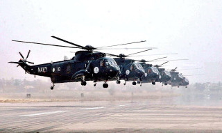 Military helicopters flying formation runway - 100mm free wallpaper