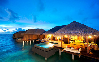 Huts on water beach night - luxury free wallpaper