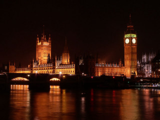 Large building clock tower night - a bridge in the foreground free wallpaper for desktop