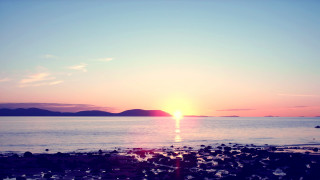 Sunset water boat mountain clouds 2 - a sunset over a body of water free wallpaper