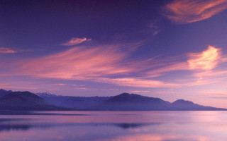 Purple sky mountains lake boat - the background and a lake in the foreground free wallpaper