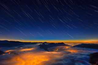 Night sky stars clouds mountain 3 - orange glow free wallpaper