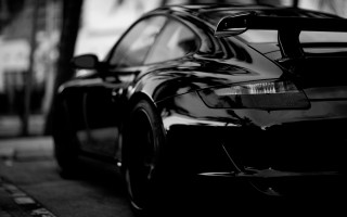 Black car parked road building - moody free wallpaper