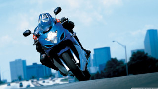 Motorcycle driving road city skyline - a city skyline free wallpaper