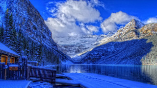 Snowy mountain lake dock cabin - a mountain range in the background free wallpaper